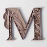Stylized wooden letter M with detailed engraved artistic design